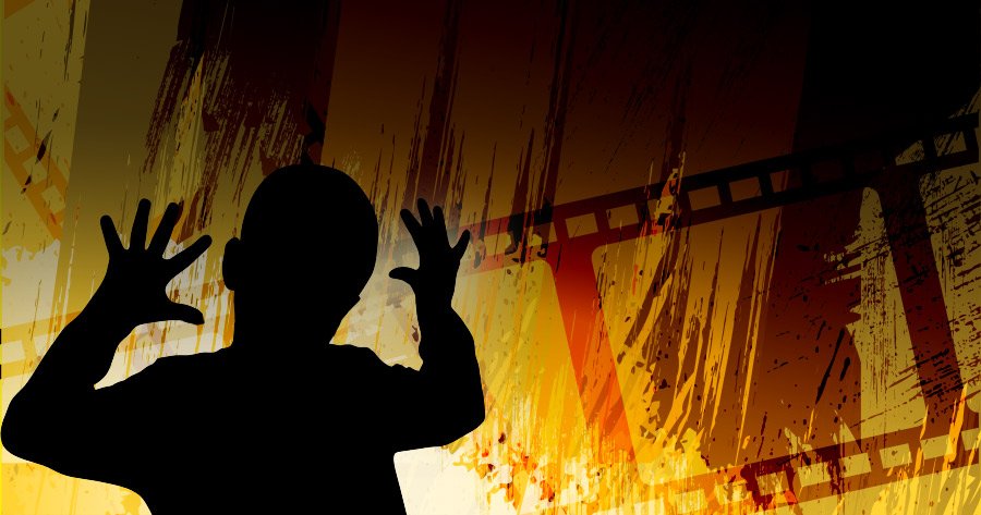 Child's silhouette in front of a film roll background